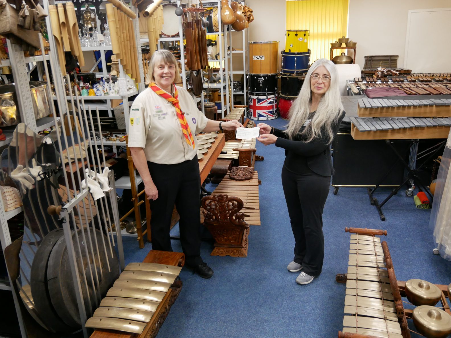 Charlotte Beattie, Scout Group Lead (left) handing over the donation of £254 to Dame Evelyn Glennie (right)